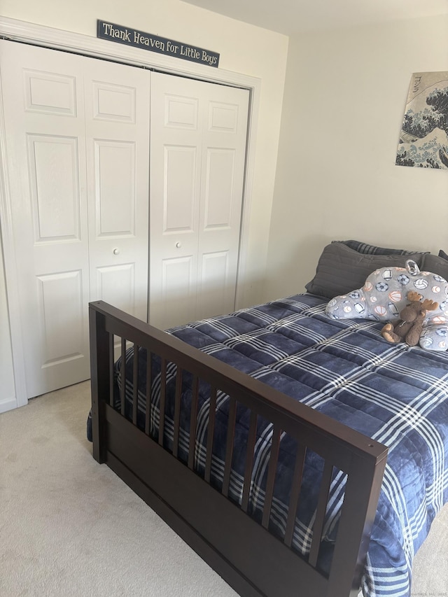 carpeted bedroom featuring a closet