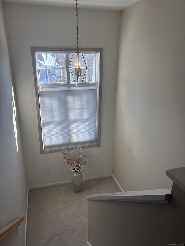 interior space featuring plenty of natural light and light carpet