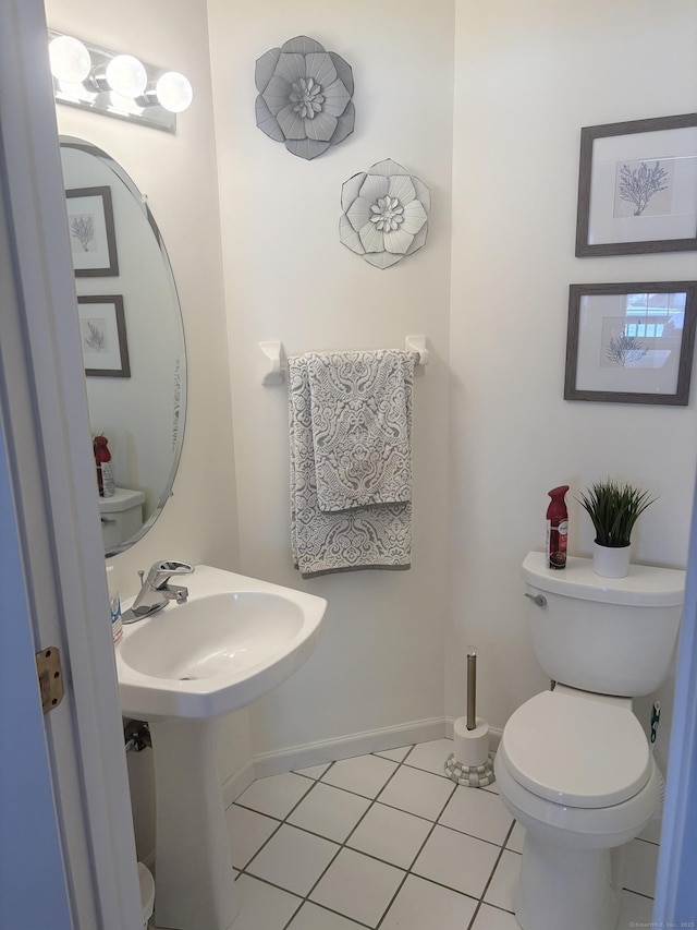 bathroom with toilet and tile patterned flooring