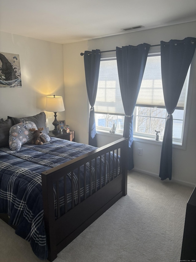 bedroom featuring multiple windows and carpet