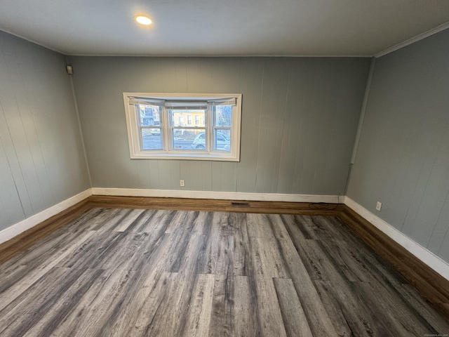 spare room with dark wood-type flooring