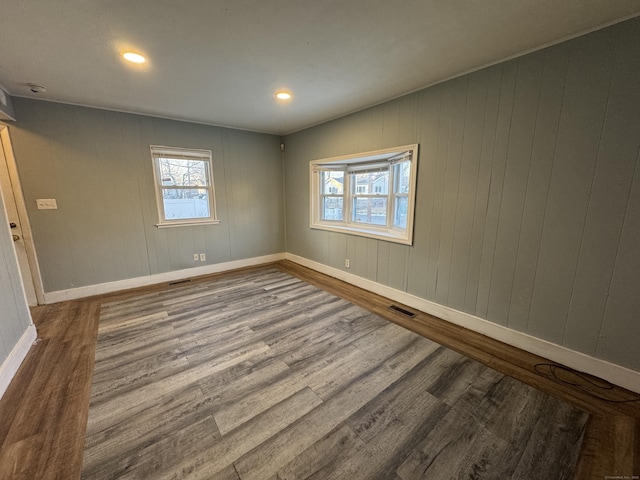 spare room with hardwood / wood-style floors and a healthy amount of sunlight