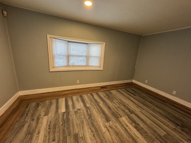 unfurnished room with wood-type flooring