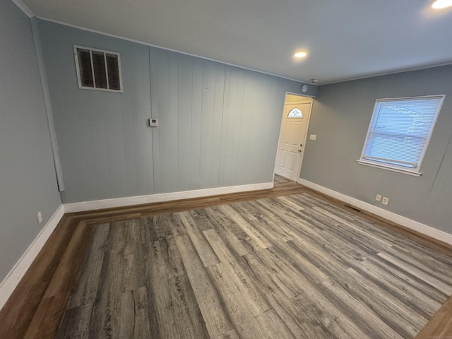 spare room featuring wood-type flooring