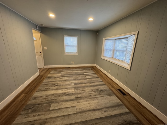 unfurnished room with wood-type flooring