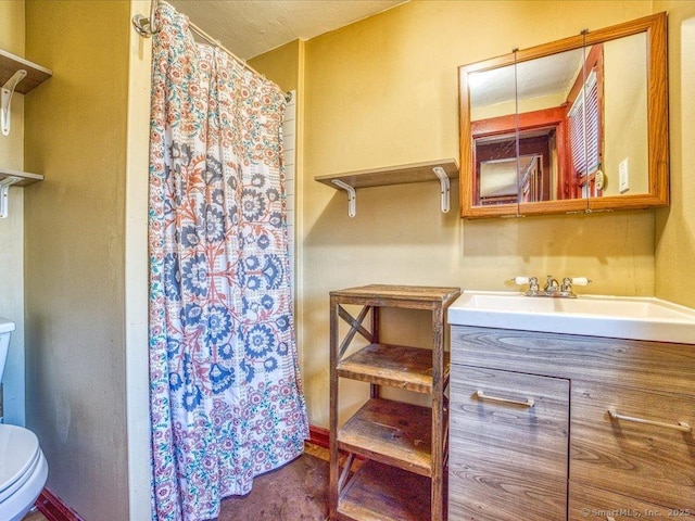 bathroom featuring vanity, a shower with shower curtain, and toilet