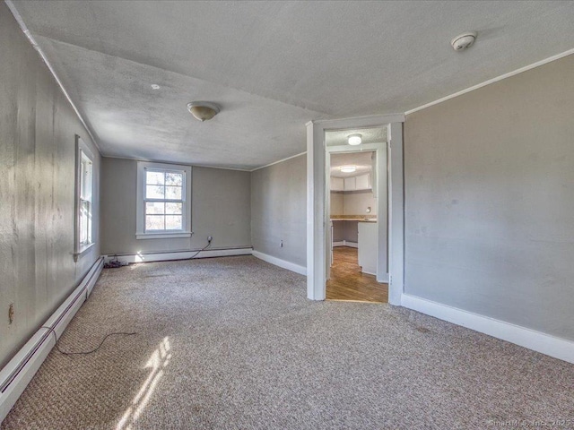 unfurnished bedroom with crown molding, carpet floors, a textured ceiling, and a baseboard radiator