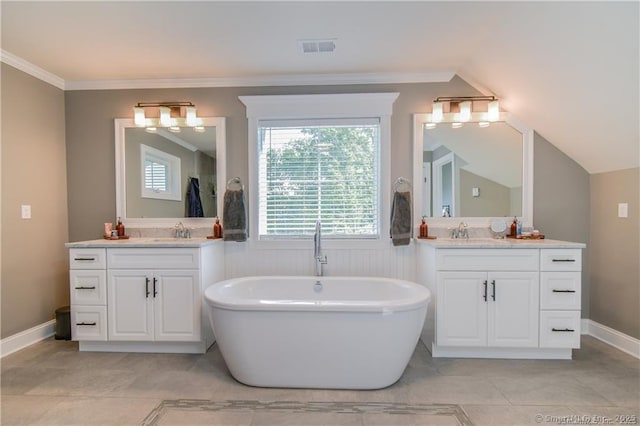 bathroom with vanity, ornamental molding, and a bathing tub