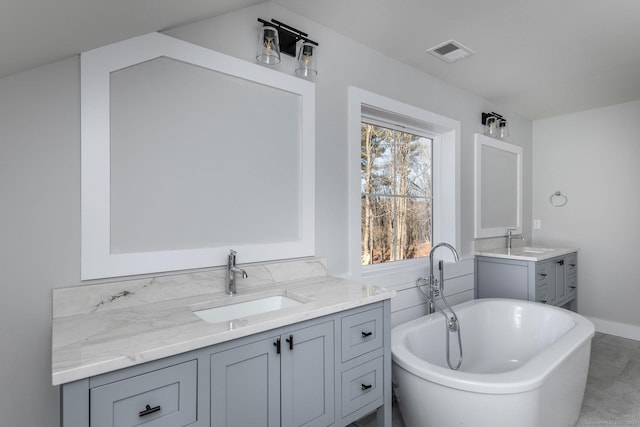 bathroom featuring vanity and a tub