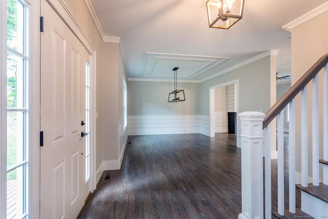 foyer featuring crown molding and dark hardwood / wood-style floors