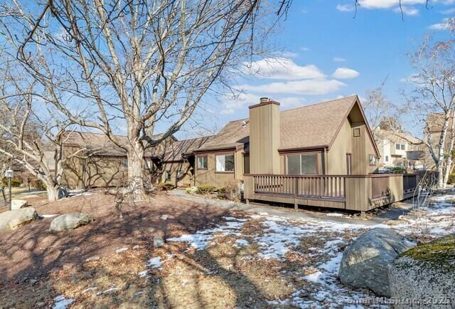 snow covered property with a deck