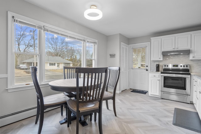 dining space with a baseboard radiator and light parquet floors