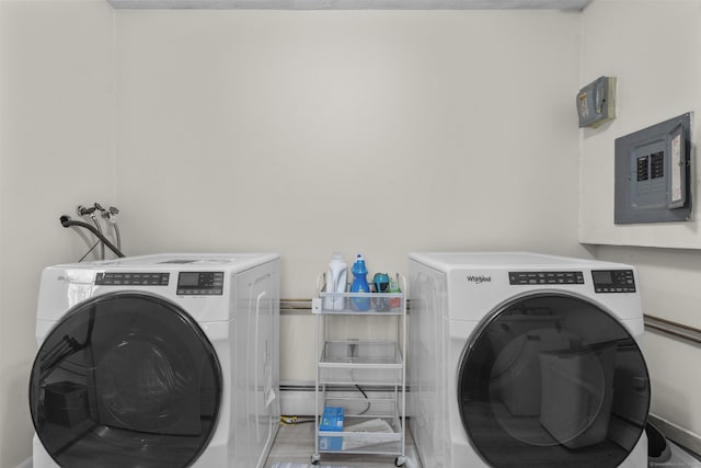 laundry area featuring separate washer and dryer, a baseboard heating unit, and electric panel