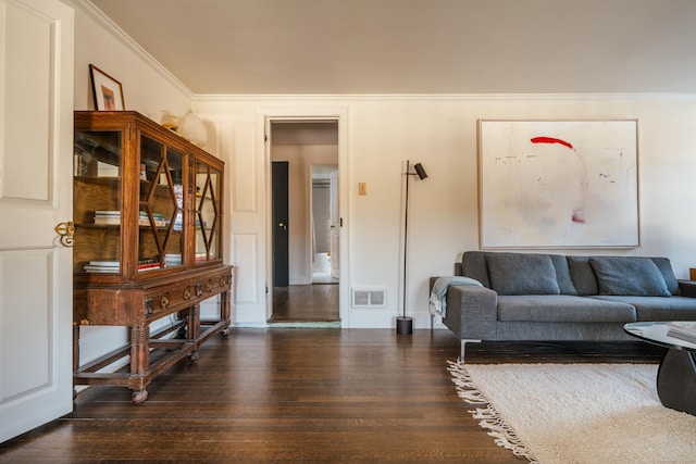 living room featuring ornamental molding and dark hardwood / wood-style floors