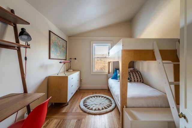 bedroom featuring light hardwood / wood-style flooring and vaulted ceiling