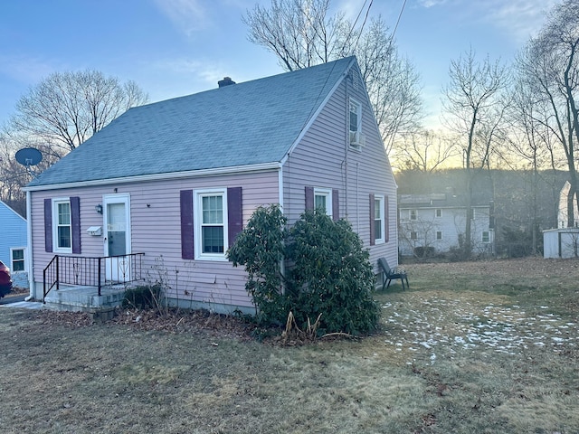 new england style home with a lawn