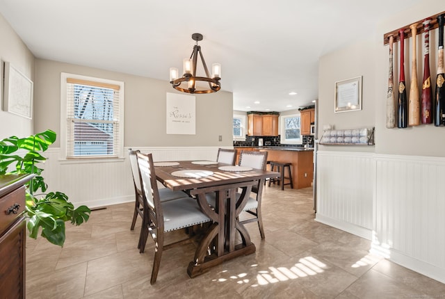 dining room with an inviting chandelier and light tile patterned flooring