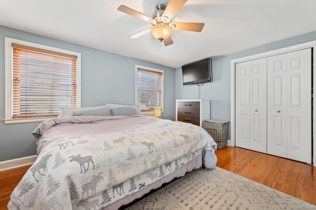 bedroom featuring wood-type flooring, a closet, and ceiling fan