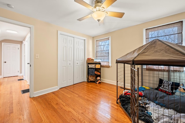 bedroom with ceiling fan, a closet, and light wood-type flooring