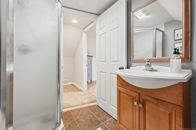 bathroom with vanity, vaulted ceiling, tile patterned floors, and walk in shower