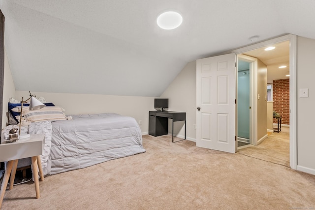 bedroom with lofted ceiling and light colored carpet