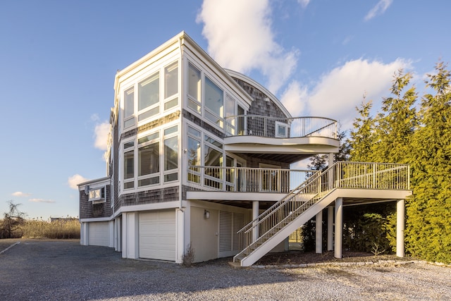 back of house with a garage and a deck