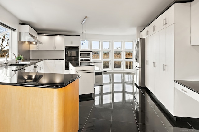 kitchen with a kitchen island, sink, white cabinets, hanging light fixtures, and black appliances