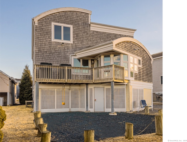 rear view of house featuring a wooden deck