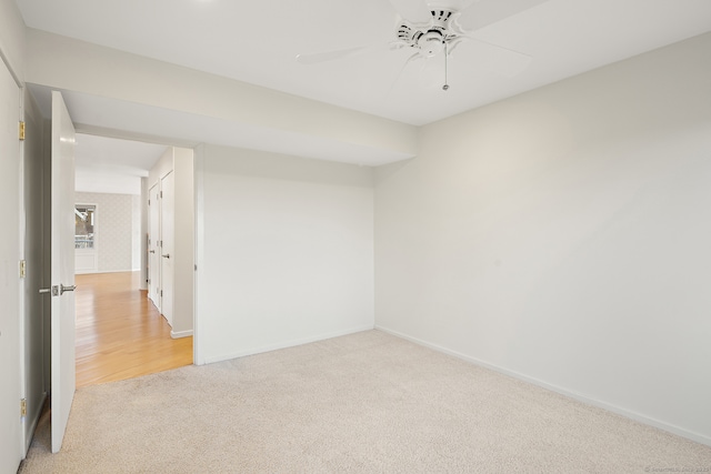 spare room with light colored carpet and ceiling fan