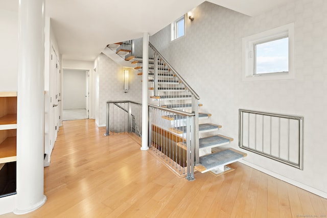 stairs featuring wood-type flooring