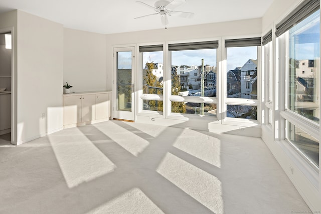 sunroom / solarium featuring ceiling fan and a wealth of natural light