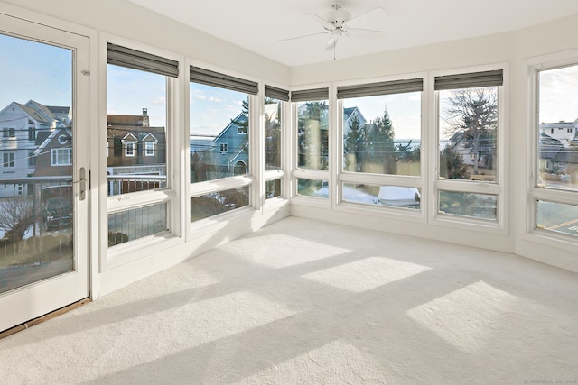 unfurnished sunroom with plenty of natural light and ceiling fan