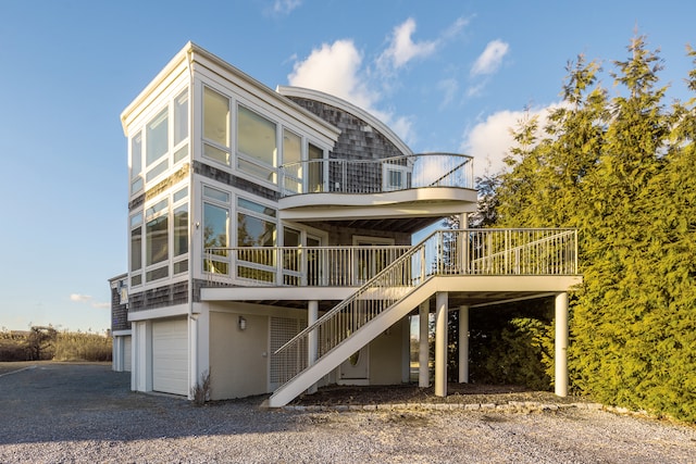 view of front facade with a garage and a wooden deck