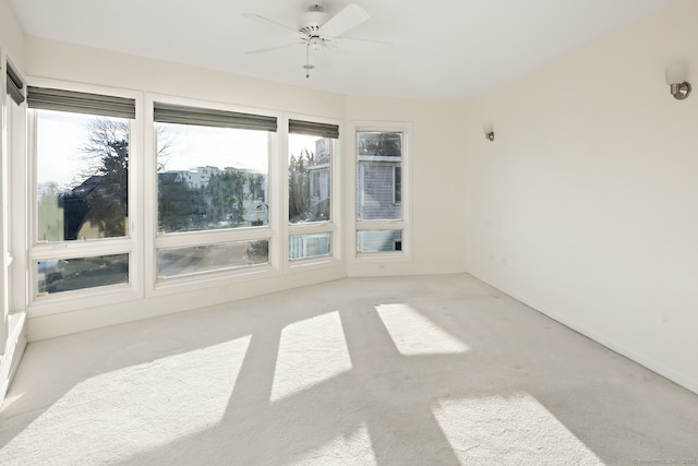 sunroom / solarium featuring ceiling fan