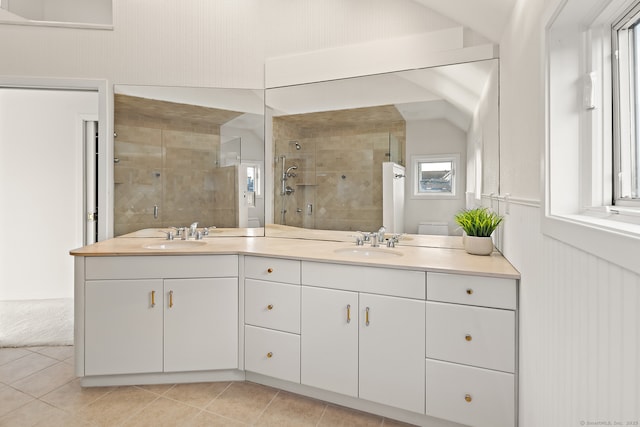 bathroom featuring vanity, a shower with shower door, and tile patterned flooring