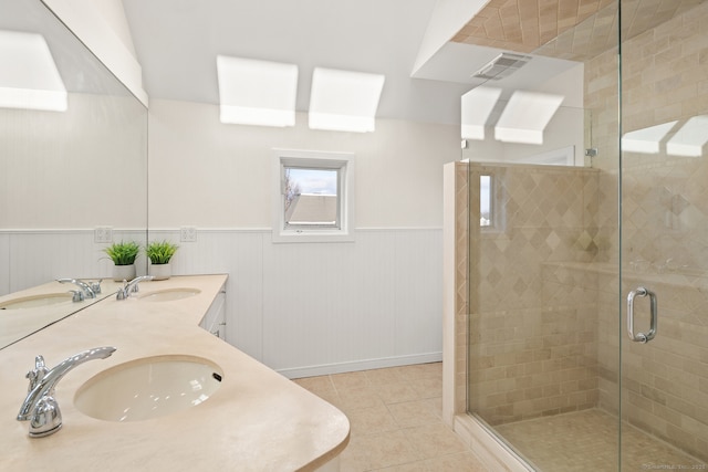 bathroom with walk in shower, vanity, and tile patterned flooring