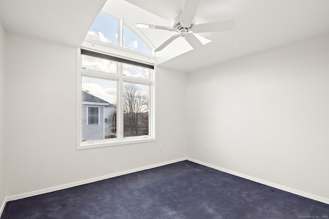 carpeted spare room featuring lofted ceiling and ceiling fan