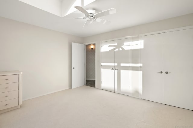 unfurnished bedroom with ceiling fan and light carpet