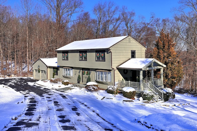 front facade featuring a garage and covered porch