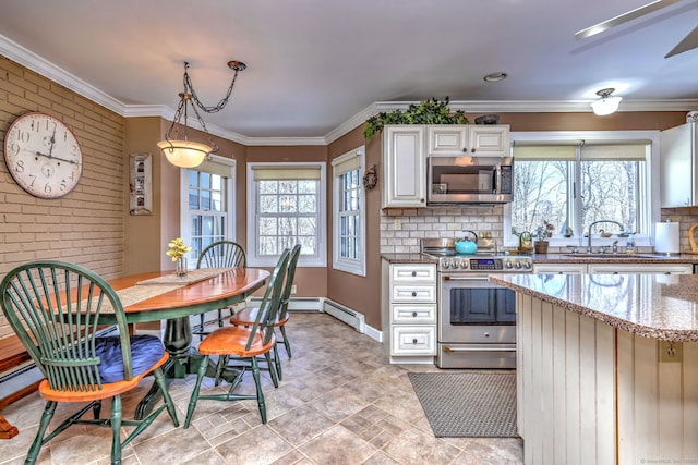 kitchen featuring sink, crown molding, appliances with stainless steel finishes, a baseboard heating unit, and light stone countertops