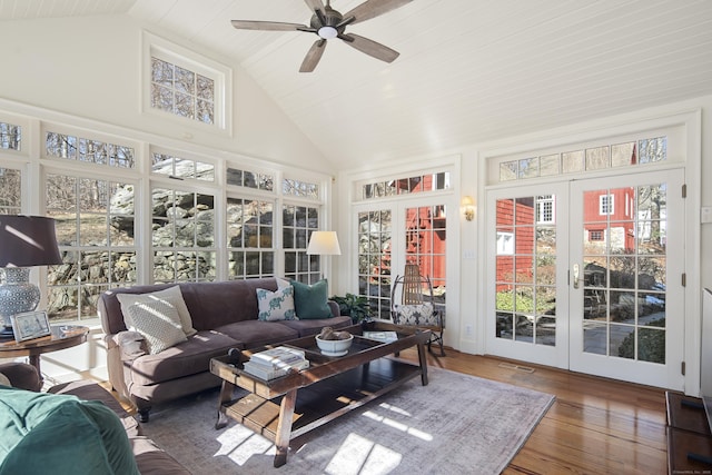 sunroom / solarium with french doors, visible vents, vaulted ceiling, and ceiling fan