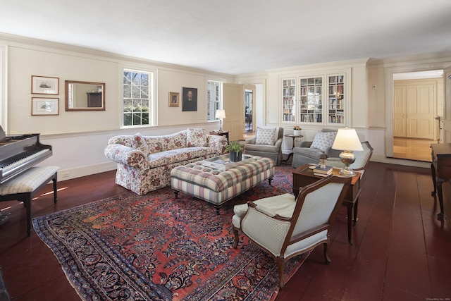 living room featuring baseboards, crown molding, and hardwood / wood-style floors