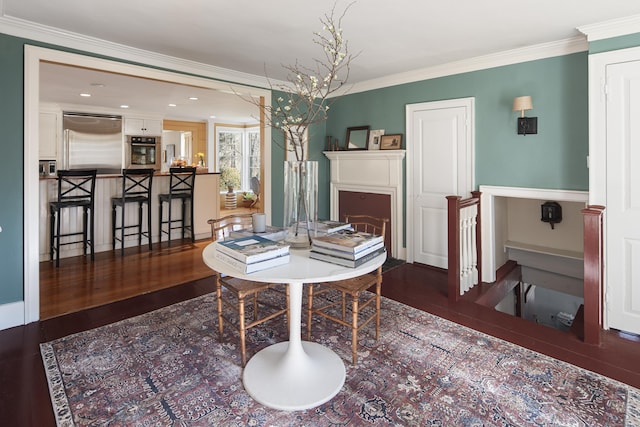 dining area with ornamental molding, recessed lighting, and wood finished floors