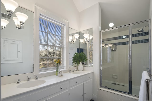 full bath with double vanity, a sink, and an inviting chandelier