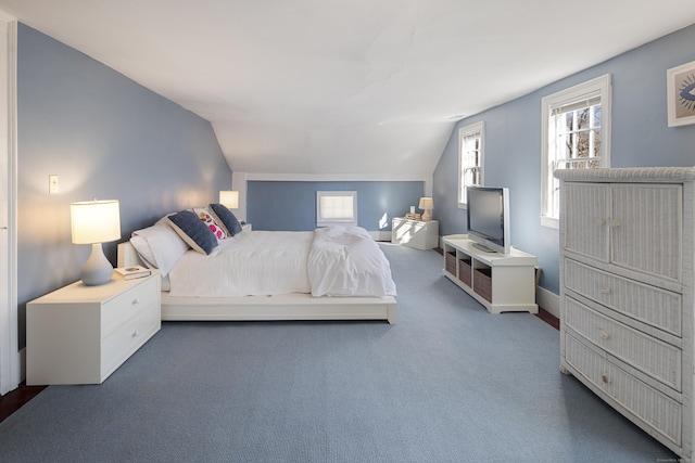 bedroom with vaulted ceiling and carpet flooring