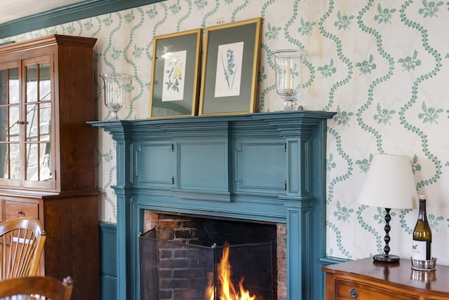 details with wallpapered walls and a lit fireplace