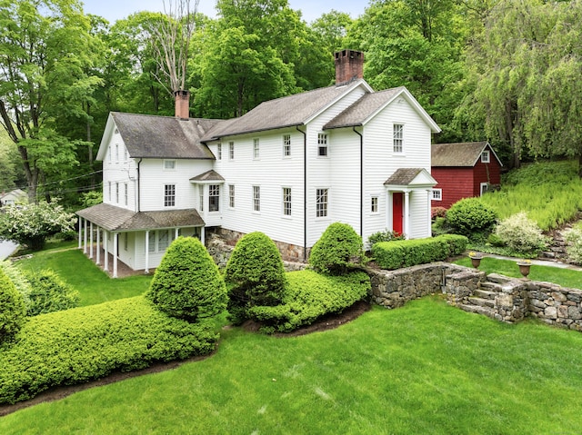 247 Mill Rd, New Canaan, CT 06840 - view of front of home with a chimney, roof with shingles, and a front yard