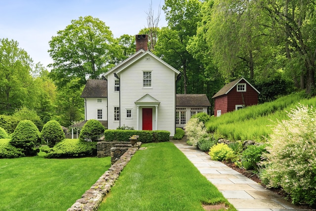 247 Mill Rd, New Canaan, CT 06840 - view of front of property featuring a chimney, a front lawn, and roof with shingles