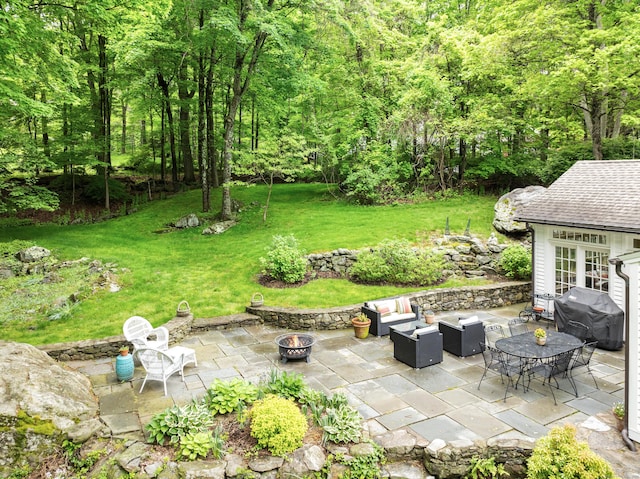 247 Mill Rd, New Canaan, CT 06840 - view of patio featuring area for grilling, an outdoor living space with a fire pit, and a wooded view