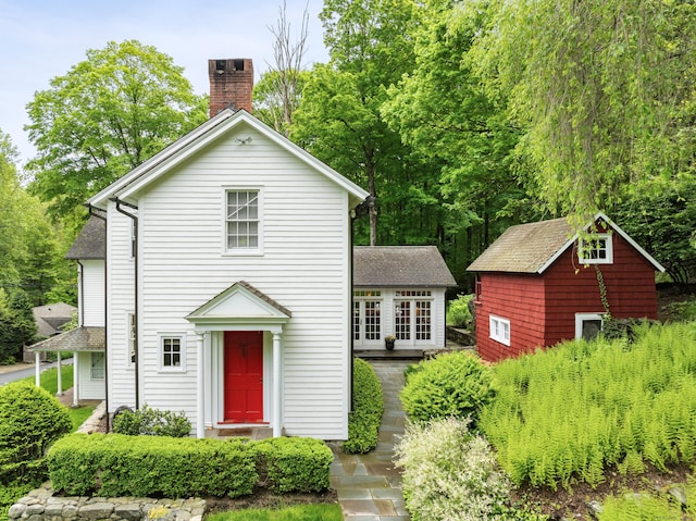 247 Mill Rd, New Canaan, CT 06840 - view of front of home with a chimney and roof with shingles